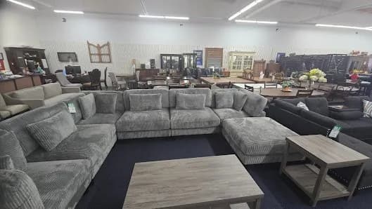 Sectional sofas, dining sets and occasional tables on the CostLess Warehouse showroom floor